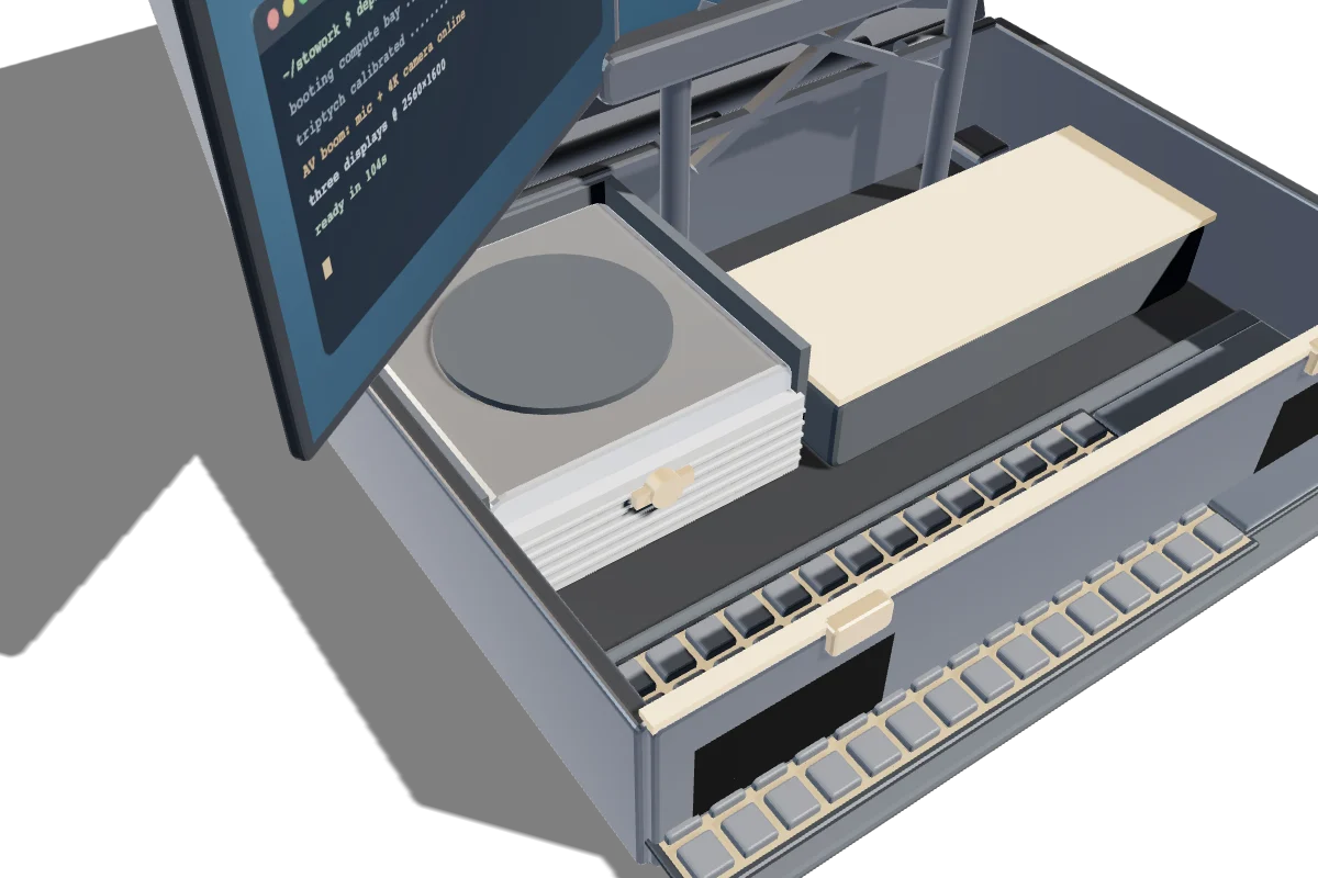 Looking down into the base: a compact computer seated in its printed cradle in the left-hand compute bay, battery beside it, keyboard tray in front.
